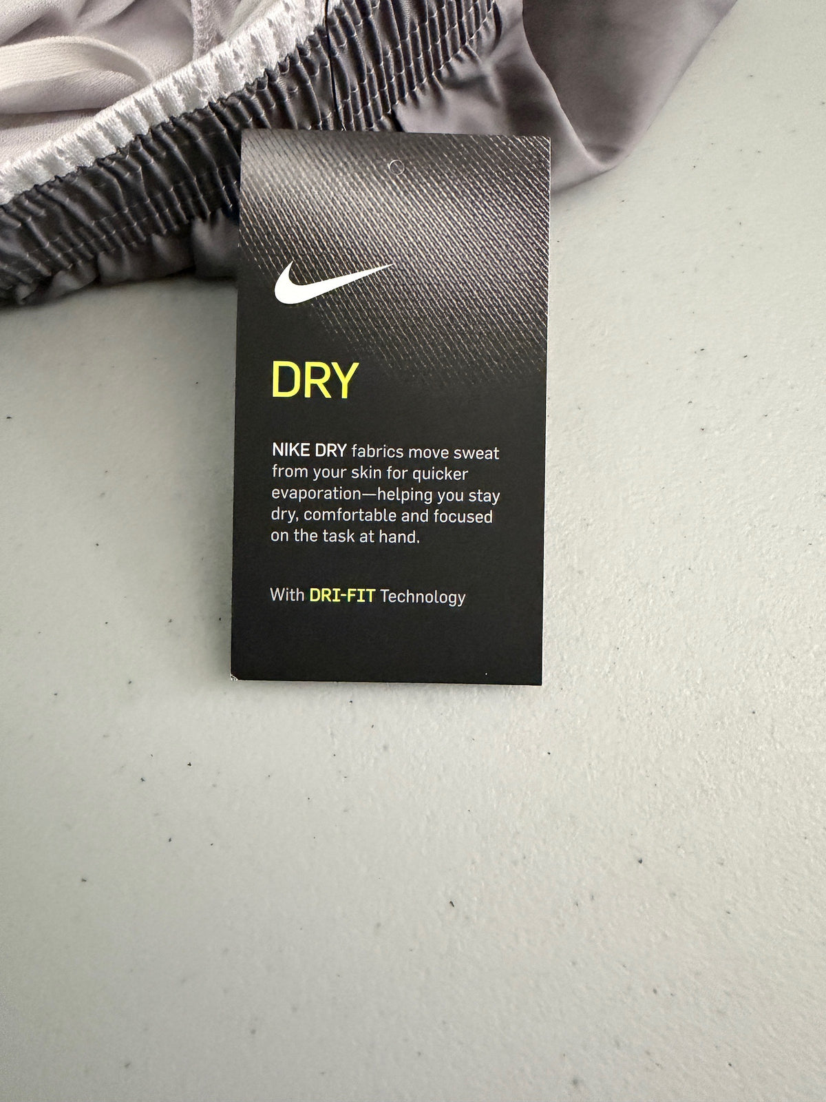 Clear view of the attached paper label of Nike XS workout shorts