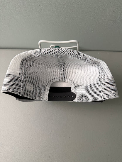 Back View: Front profile shot of a brand new New Era New York Jets The Golfer snapback hat featuring a green and white sublimated tie dye front panel, premium embroidered white jets logo, gray structured brim, and breathable white mesh trucker backing. 