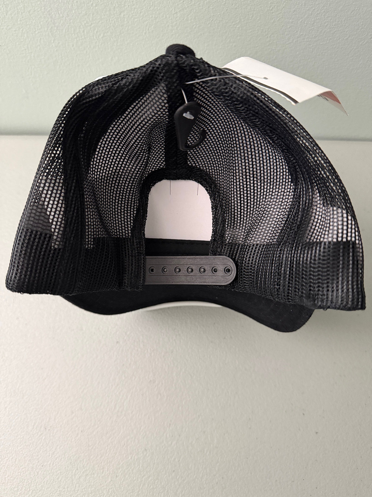 Back View: Brand new Toyota Off-Road Racing rope trucker hat in black and white, featuring a large embroidered retro shield logo patch, checkerboard racing stripes, and a braided white rope detail on a snapback cap from Bell's Bargain Barn.