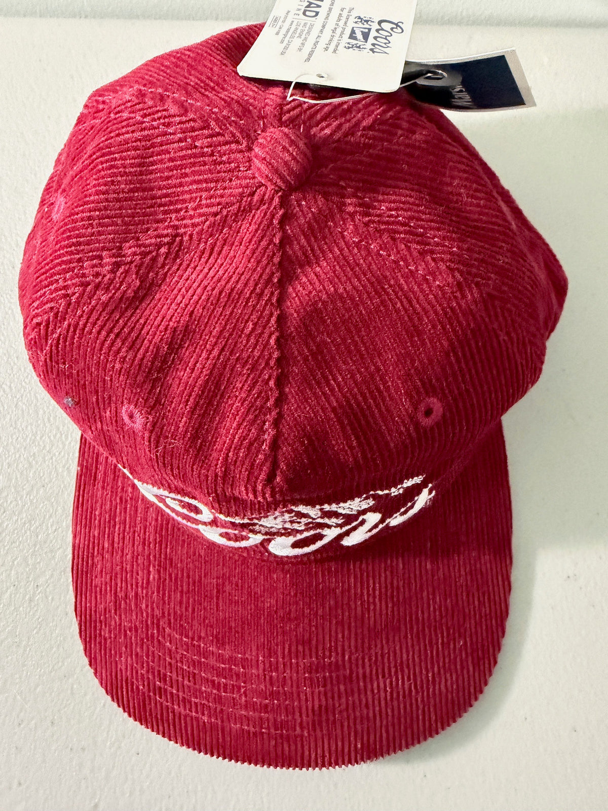 Top View: Brand new Coors Banquet Beer corduroy baseball hat featuring a deep maroon structured corduroy crown and brim, white embroidered classic script logo on the front panel, and an adjustable snapback closure from Bell's Bargain Barn.