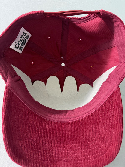 Inside View: Brand new Coors Banquet Beer corduroy baseball hat featuring a deep maroon structured corduroy crown and brim, white embroidered classic script logo on the front panel, and an adjustable snapback closure from Bell's Bargain Barn.