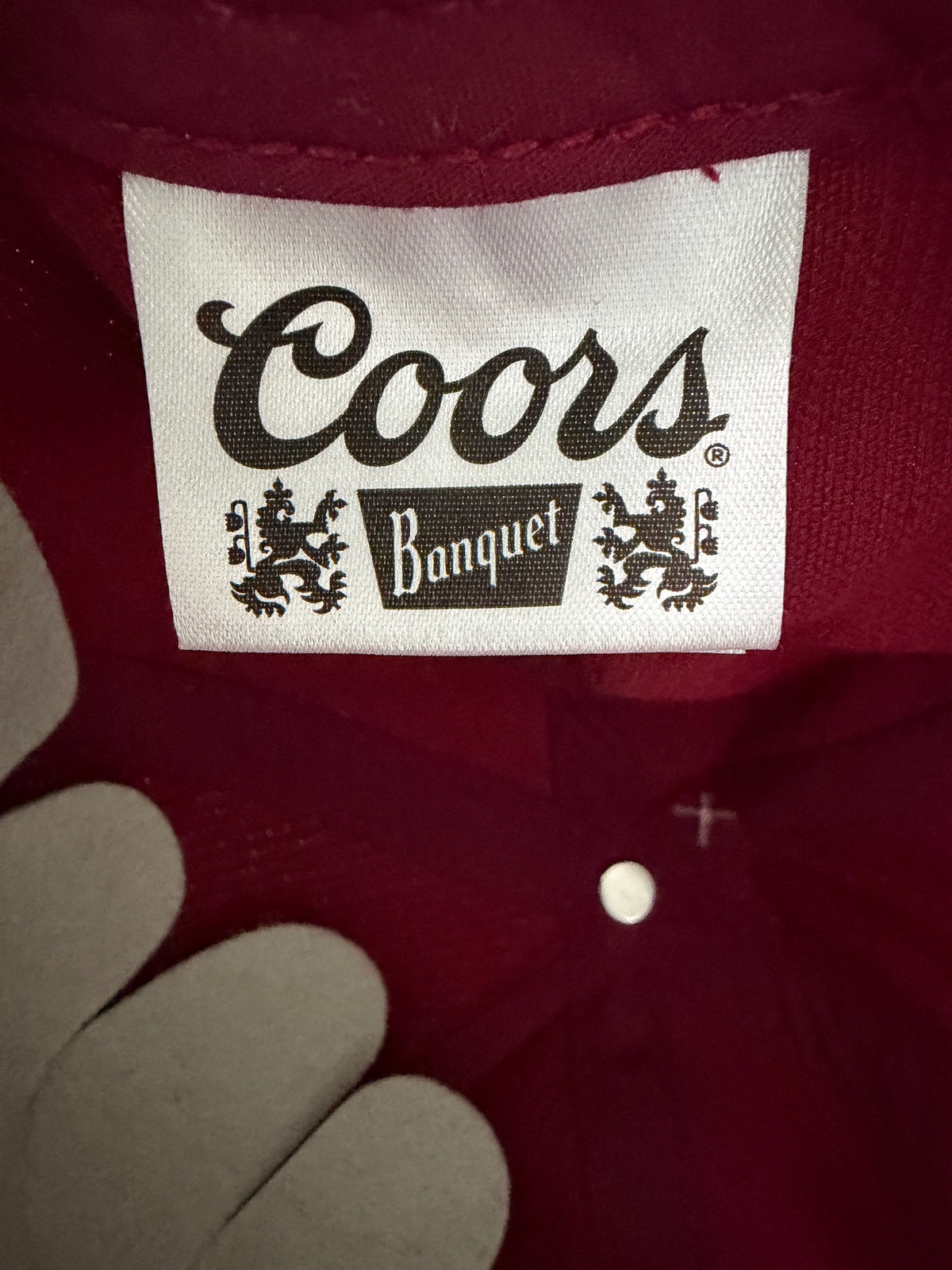 Brand Tag View: Brand new Coors Banquet Beer corduroy baseball hat featuring a deep maroon structured corduroy crown and brim, white embroidered classic script logo on the front panel, and an adjustable snapback closure from Bell's Bargain Barn.