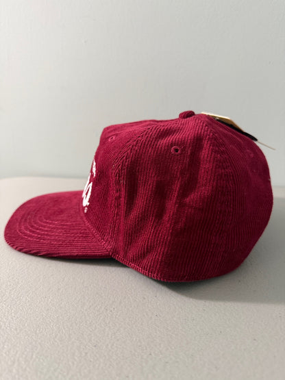 Side View: Brand new Coors Banquet Beer corduroy baseball hat featuring a deep maroon structured corduroy crown and brim, white embroidered classic script logo on the front panel, and an adjustable snapback closure from Bell's Bargain Barn.