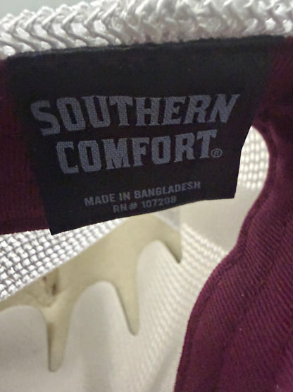 Product Brand Tag: Brand new Southern Comfort Take It Easy mesh trucker hat featuring a structured maroon front foam panel, raised gold cursive lettering, white mesh back panels, a patterned front visor accent rope, and an adjustable snapback closre from Bell's Bargain Barn. 