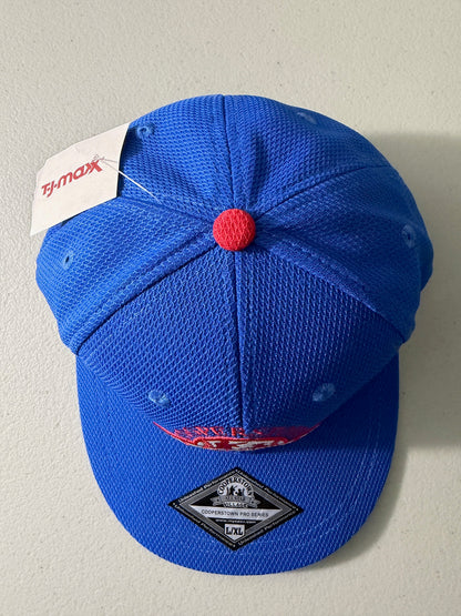 Top View: Brand new royal blue Cooperstown All Star Pro Village Pro Series stretch fit baseball hat featuring an embroidered red and white tournament patch, a diamond-shaped L/XL silver visor sticker, and an athletic mesh-textured crown from Bell's Bargain Barn. 