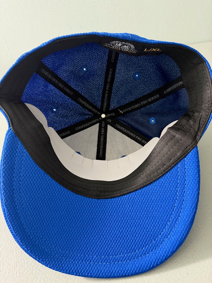 Inside View: Brand new royal blue Cooperstown All Star Pro Village Pro Series stretch fit baseball hat featuring an embroidered red and white tournament patch, a diamond-shaped L/XL silver visor sticker, and an athletic mesh-textured crown from Bell's Bargain Barn. 
