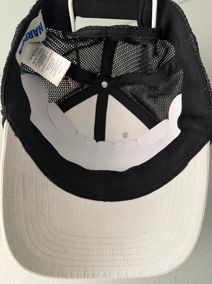 Inside View: Brand new Harpoon Brewery Est. 198 mid crown fit trucker hat featuring a structured off-white front panel with a black embroidered logo patch, black mesh backing, a thin black visor rope, and a blue brim sticker from bell's Bargain Barn.