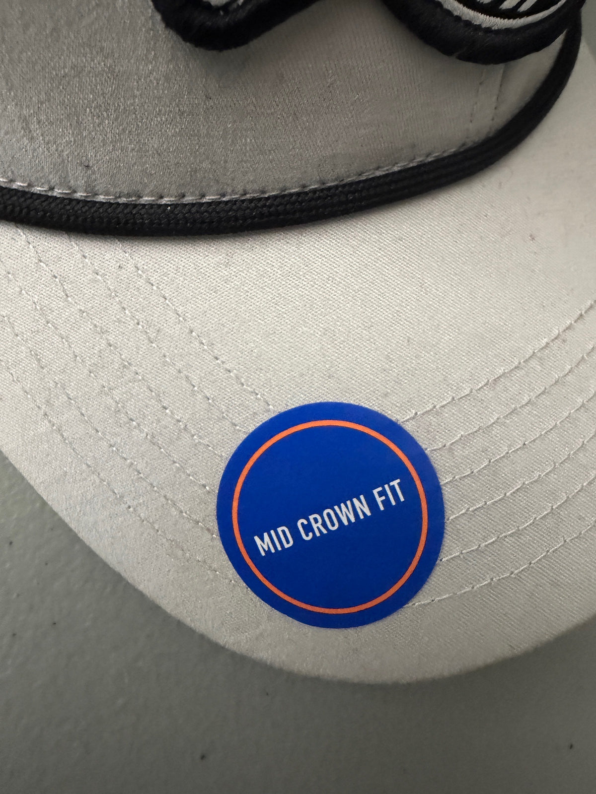 Brim Sticker View: Brand new Harpoon Brewery Est. 198 mid crown fit trucker hat featuring a structured off-white front panel with a black embroidered logo patch, black mesh backing, a thin black visor rope, and a blue brim sticker from bell's Bargain Barn.