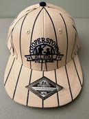 Brand new cream Cooperstown All Star Village Pro Series stretch fit baseball hat with navy blue pinstripes, featuring an embroidered navy tournament logo patch and a silver diamond-shaped L/XL visor sticker from Bell's Bargain Barn.  