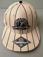 Brand new cream Cooperstown All Star Village Pro Series stretch fit baseball hat with navy blue pinstripes, featuring an embroidered navy tournament logo patch and a silver diamond-shaped L/XL visor sticker from Bell's Bargain Barn.  