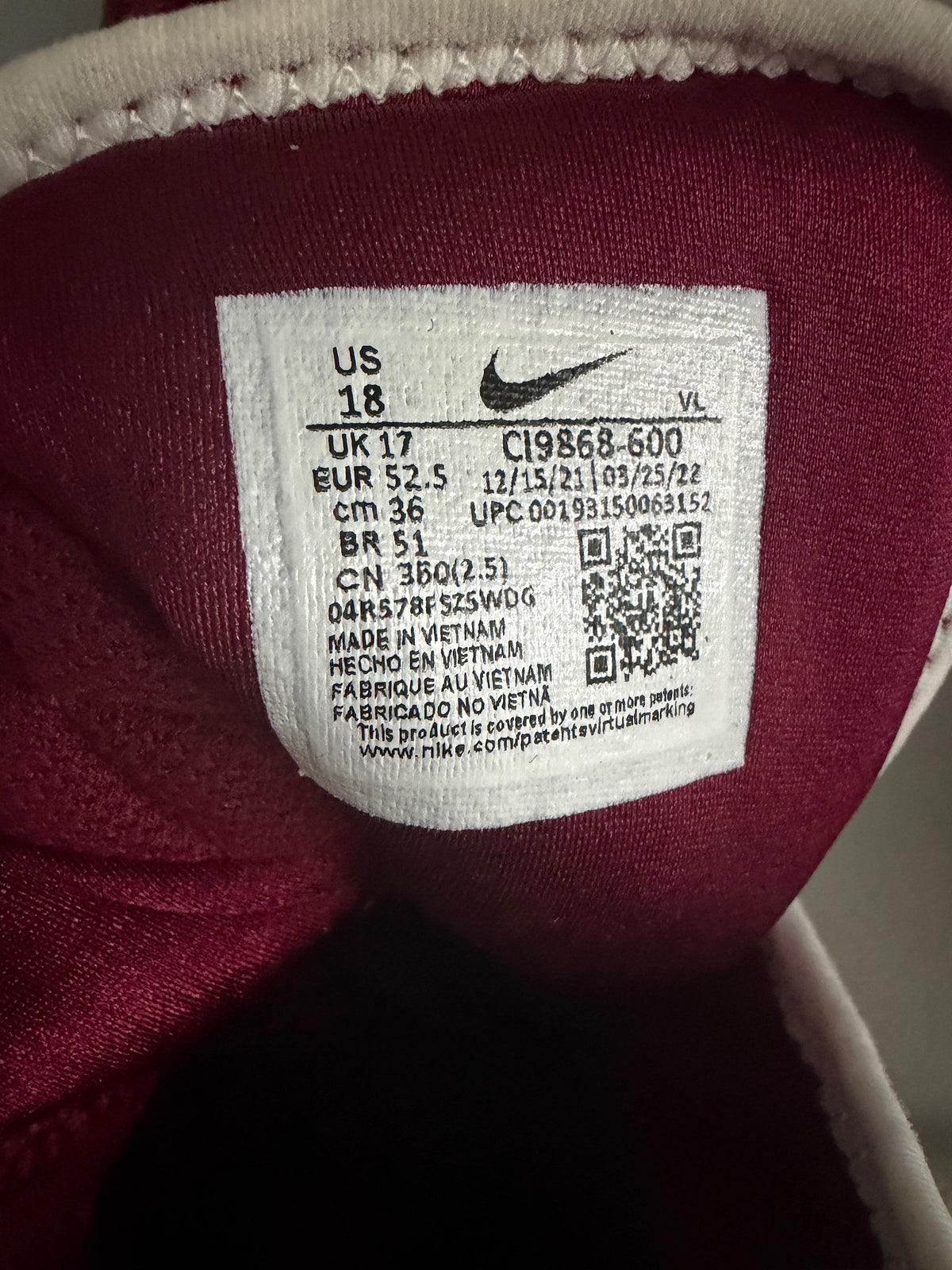 Close-up of Nike football cleat size tag and QR code for model C19868-600 in US Men's Size 