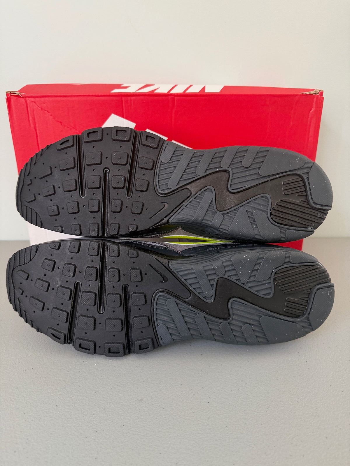 Sole / Bottom View: Bottom outsole tread view of Nike Air Max Excee showing black and grey rubber grip pattern. 