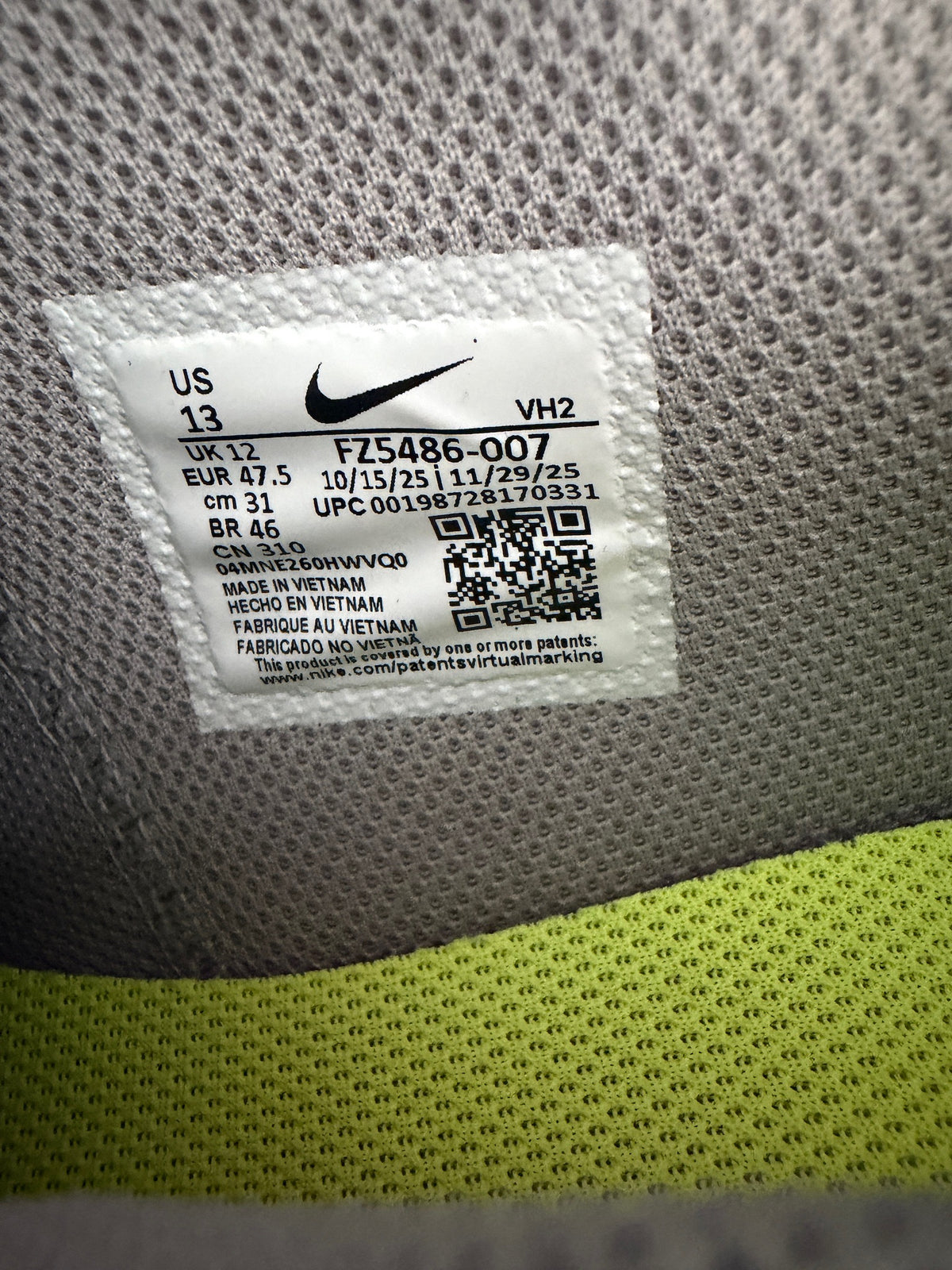 Inside Tag View: inside stiched tag showing authentic Nike branding, size US 13 details, and model code FZ5486-007