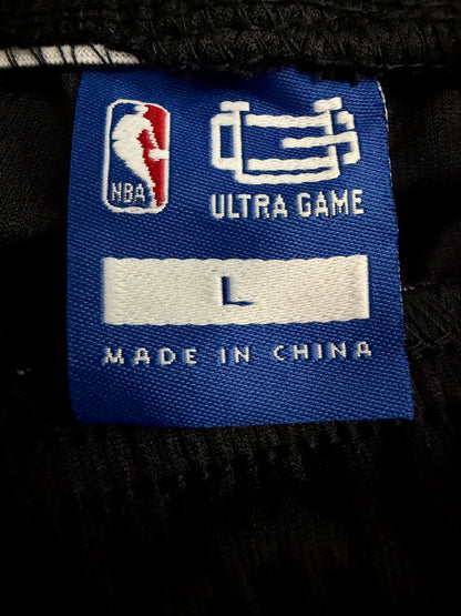 Close-up of the official NBA licensed embroidered tag on the inside of Boston Celtics shorts.