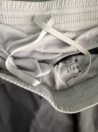 Interior view of the elastic waistband on Nike 10K shorts, highlighting the internal drawstring.