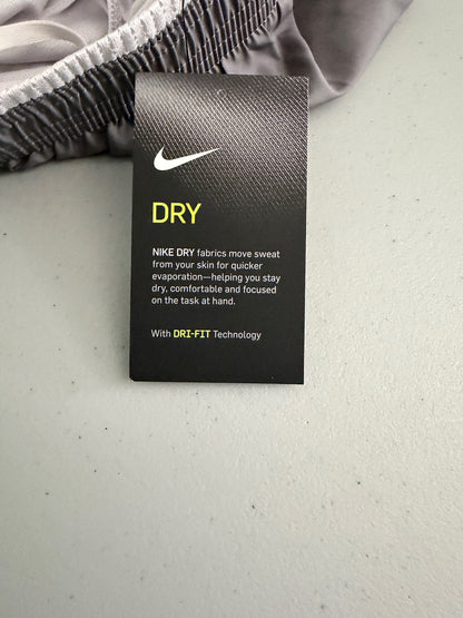 Clear view of the attached paper label of Nike XS workout shorts 