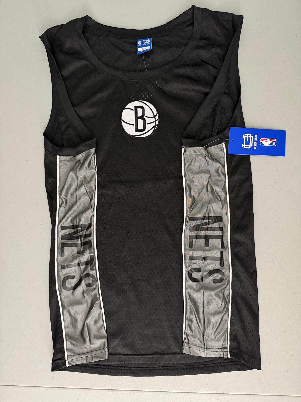 Side view of the Brooklyn Nets basketball tank top highlighting the athletic gray side panel fabric detail and stitching.  