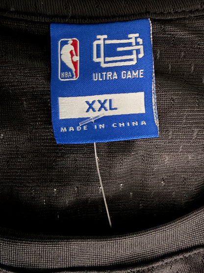 Close-up of the official inside fabric brand tag on the Brooklyn Nets tank top, showing the Ultra Game logo and XXL size marking.