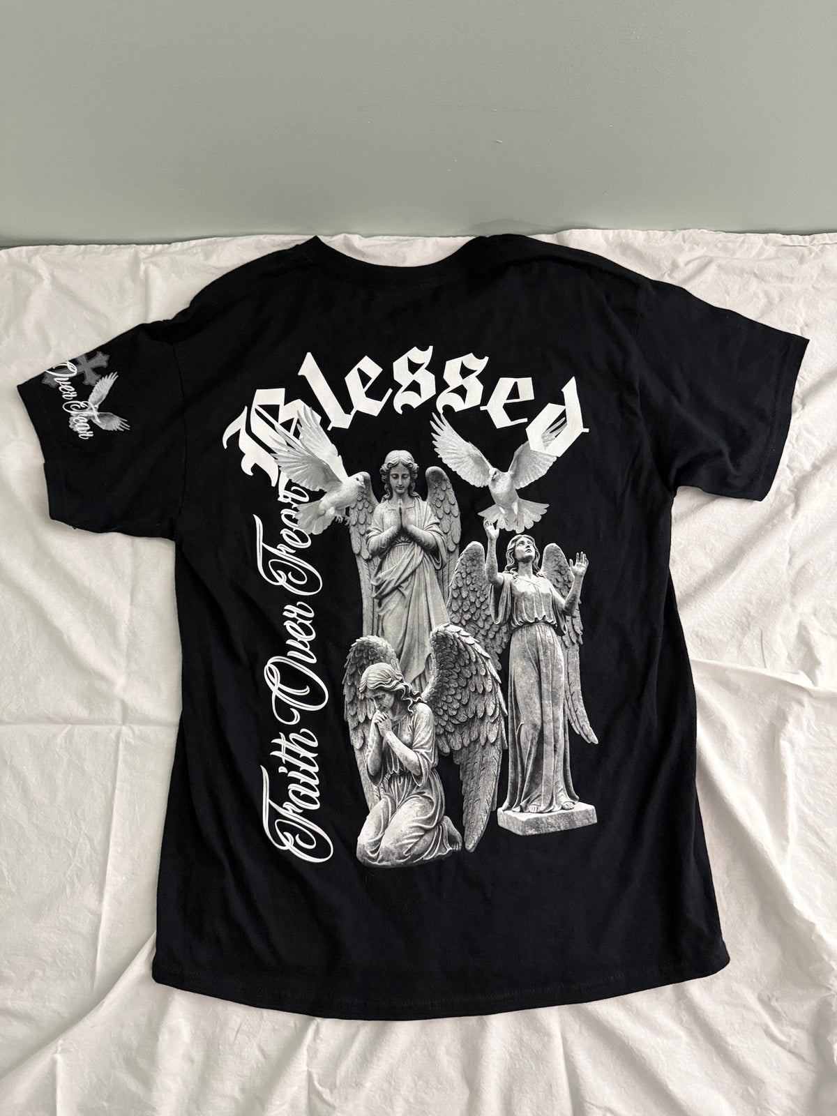 Back View of Popular Poison "The World Is Yours" black graphic tee. Features a white and gray angel and dove statue streetwear graphic print. Brand new with tags. 