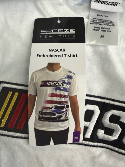 Cardboard Hang Tag: Close-up of retail cardboard hand tag attached to the white NASCAR t-shirt, clearly showing the official manufacturer logo and authentic merchandise details. 