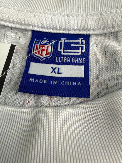 Close-up of the official attached merchandise tags on the Ultra Game shirt, showcasing the NFL logo shield, the Ultra Game Day brand name, size marking XL, and printed garment care instructions for machine washing. 